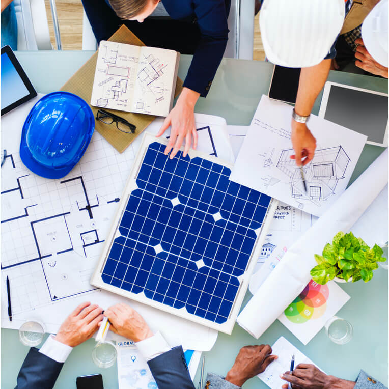 People gathered around blueprints