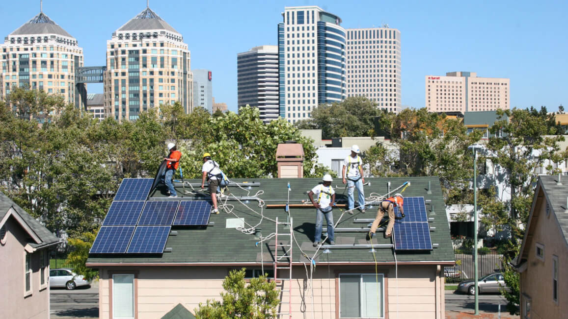 Men installing solar panels on roof